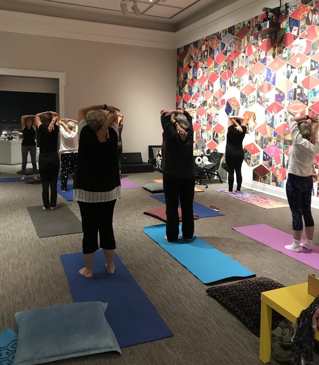 Adults doing yoga in the Ackland galleries